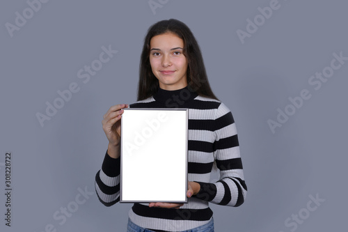 girl holding blank vertical canvas in hands empty frame mock-up poster © Bonsales
