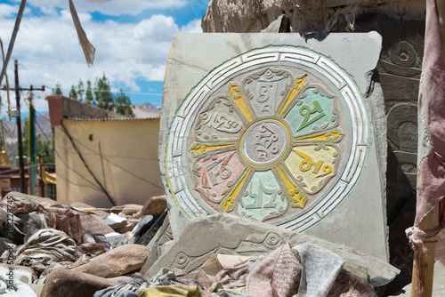 Ladakh, India - Jul 03 2019 - Mani Stone at Choglamsar Town in Ladakh, Jammu and Kashmir, India. Mani stones are stone plates as a form of prayer in Tibetan Buddhism. photo