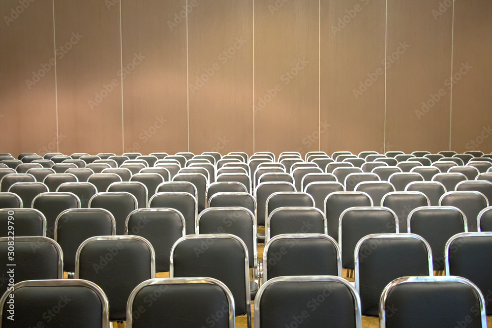 Fototapeta premium Black empty seats in the audience prepared for the participants of the conference or presentation. Organization and holding of mass events