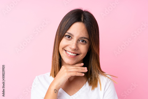 Young woman over isolated pink background