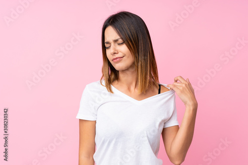 Young woman over isolated pink background with tired and sick expression © luismolinero