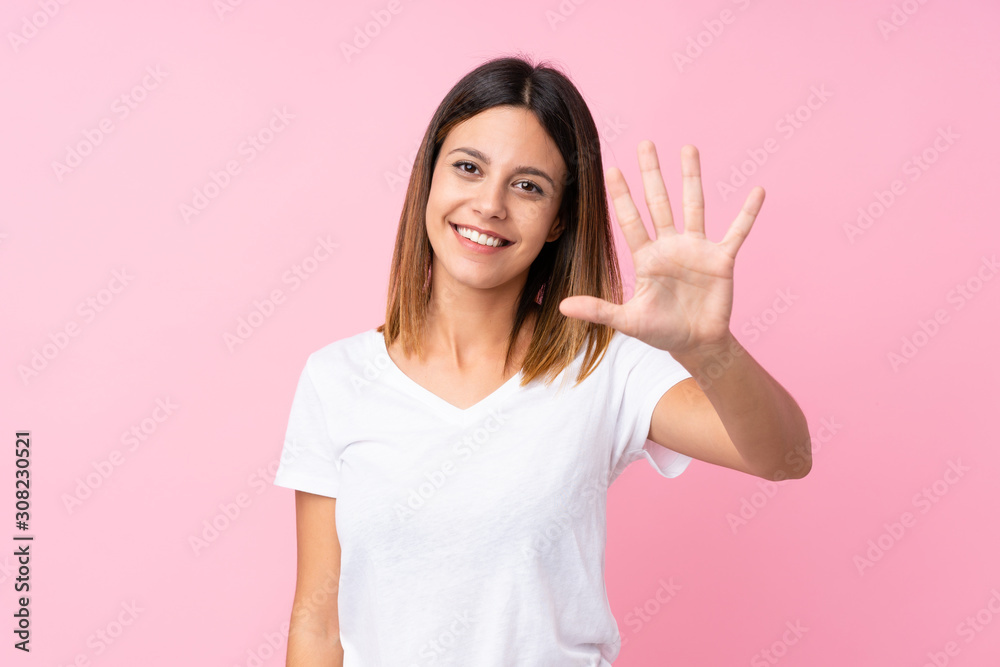 Young woman over isolated pink background counting five with fingers Young woman over isolated pink background counting five with fingers