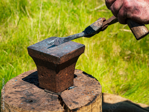 manual workman, divorced craftsman, Germany - An old blacksmith's craft shapes a knife with a hammer and anvil.