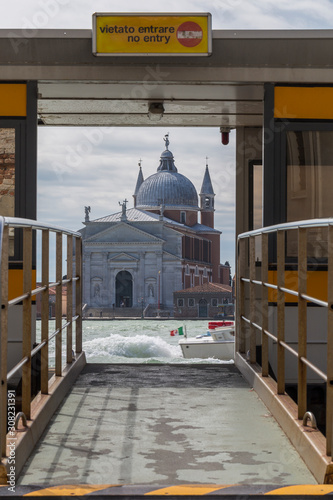 Vaporetto water bus stop Spirito Santo in Venice. Entrance frames beautiful vista towards Chiesa del Santissimo Redentore
