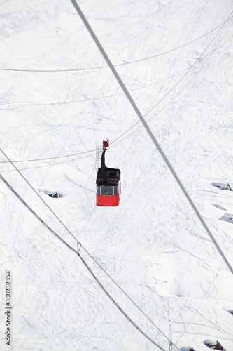 Magnificent view of the snow-white towering mighty mountains Elbrus and the cable ways, ski resort, Kabardinobalkaria, Russia photo
