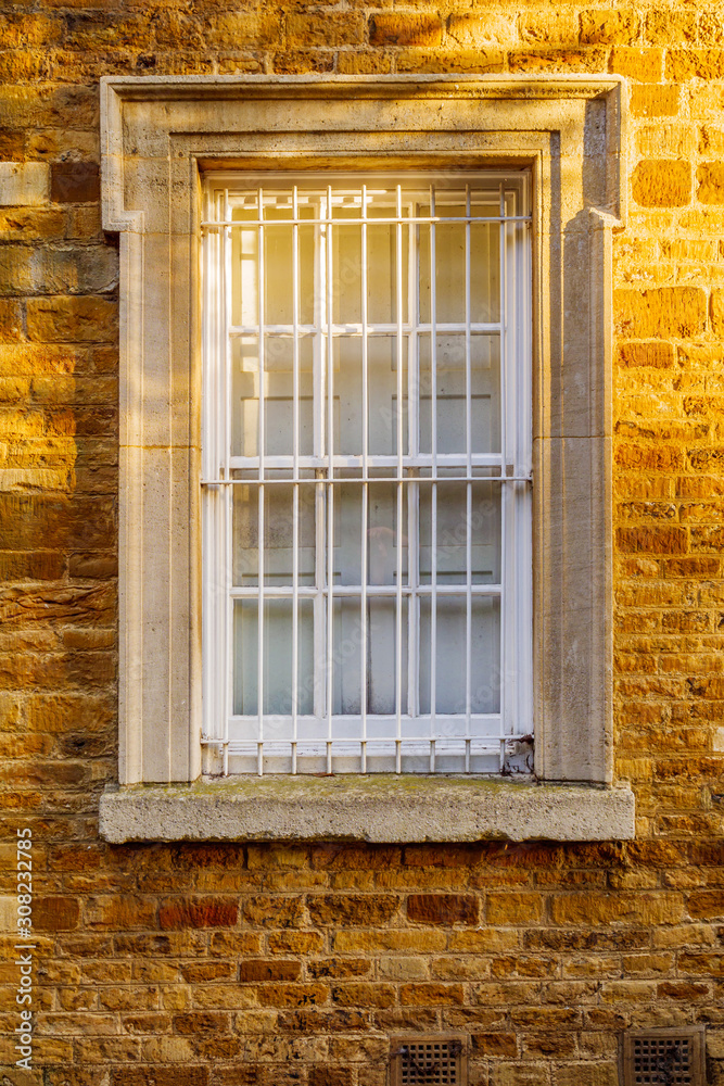 old stone wall with window in england uk on sunny evening