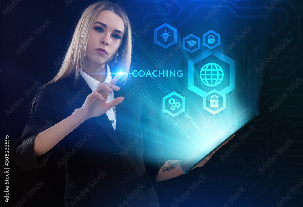 Business, Technology, Internet and network concept. Young businessman working on a virtual screen of the future and sees the inscription: Coaching Business, Technology, Internet and network concept. Young businessman working on a virtual screen of the future and sees the inscription: Coaching