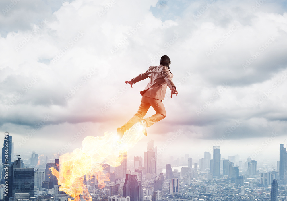 Businessman in suit and aviator hat flying in sky Businessman in suit and aviator hat flying in sky