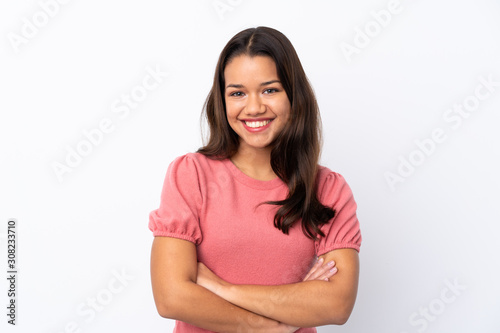 Young Colombian girl over isolated white background keeping the arms crossed in frontal position