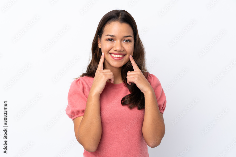 Young Colombian girl over isolated white background smiling with a happy and pleasant expression Young Colombian girl over isolated white background smiling with a happy and pleasant expression
