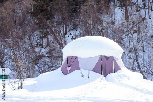 Snow-covered tent in winter in the park in the mountains Elbrus, ski resort, the Republic of Kabardino-Balkaria, Russia.