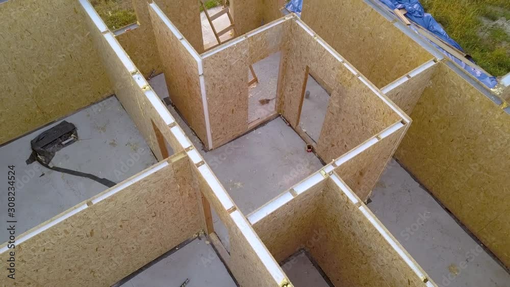 Construction of new and modern modular house. Walls made from composite wooden sip panels with styrofoam insulation inside. Building new frame of energy efficient home concept.