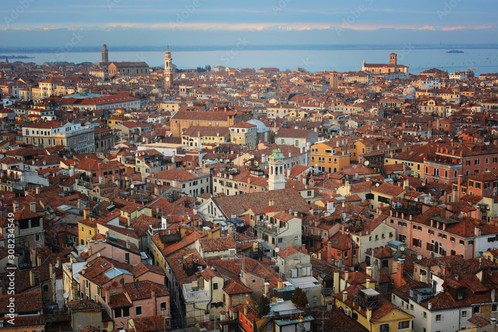 Aerial view of Venice roofs, old city and house buildings in Italy. Top view of traditional buildings in the center of Venice. Skyline in the city, view of the red roofs from the tower.
