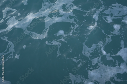 The texture of sea water and foam. Blue waves. Creative vintage background.