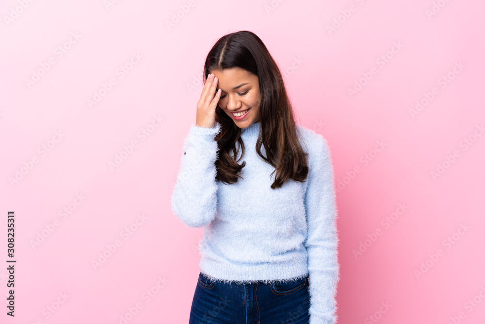 Young Colombian girl over isolated pink background laughing Young Colombian girl over isolated pink background laughing