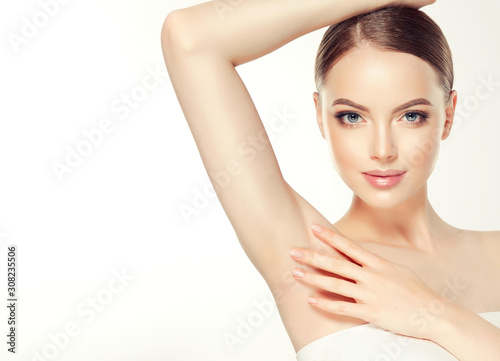 Armpit epilation, lacer hair removal. Young woman holding her arms up and showing clean underarms, depilation  smooth clear skin .Beauty portrait. photo