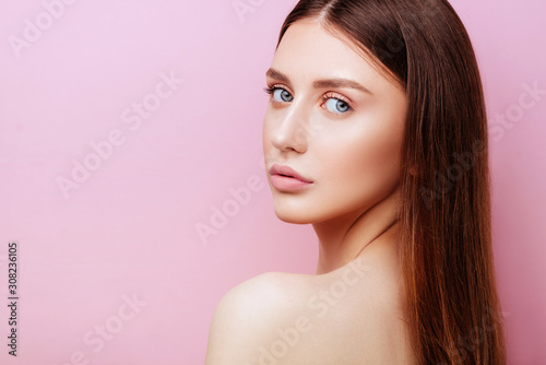 Beauty cute fashion model with natural make up on pink background