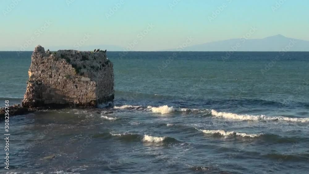 ruins of old fortress are washed by a calm sea ruins of old fortress are washed by a calm sea