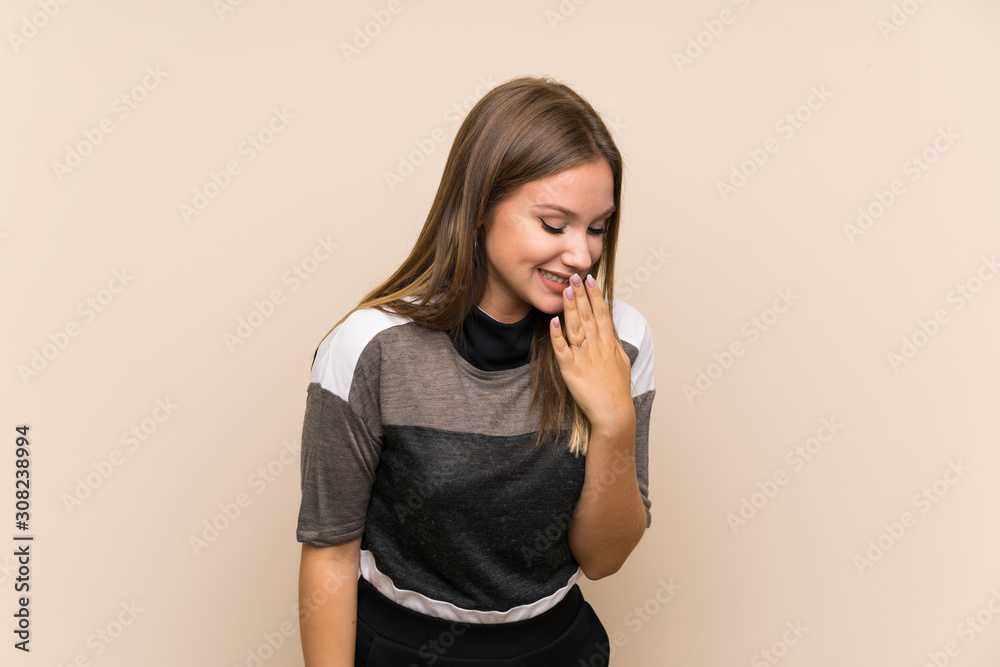 Teenager girl over isolated background smiling a lot Teenager girl over isolated background smiling a lot