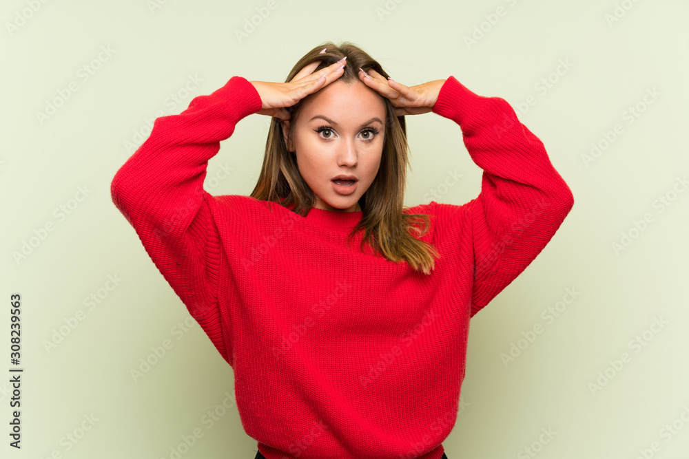 Teenager girl over isolated green background with surprise facial expression