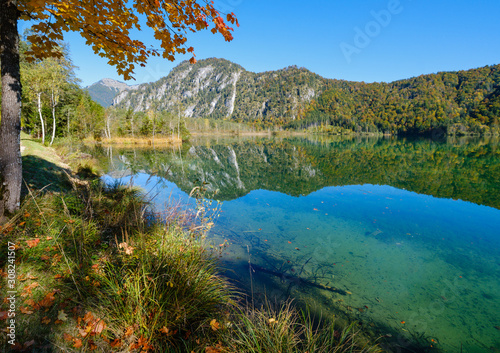 Fototapeta Naklejka Na Ścianę i Meble -  Peaceful autumn Alps mountain lake with clear transparent water and reflections. Almsee lake, Upper Austria.