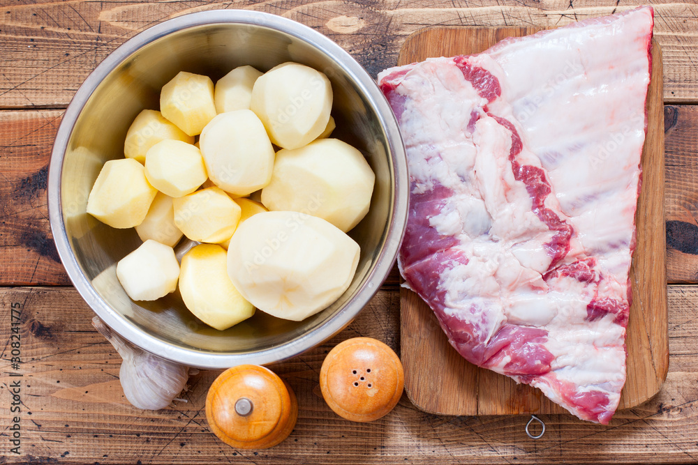 Step-by-step preparation of pork ribs with potatoes in the oven, step 1- preparation of ingredients, top view, selective focus Step-by-step preparation of pork ribs with potatoes in the oven, step 1- preparation of ingredients, top view, selective focus