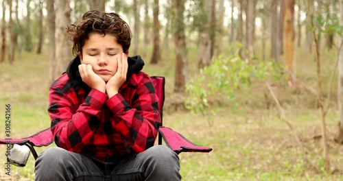 Serious Offended Young Boy Looking At The Camera at the outdoors