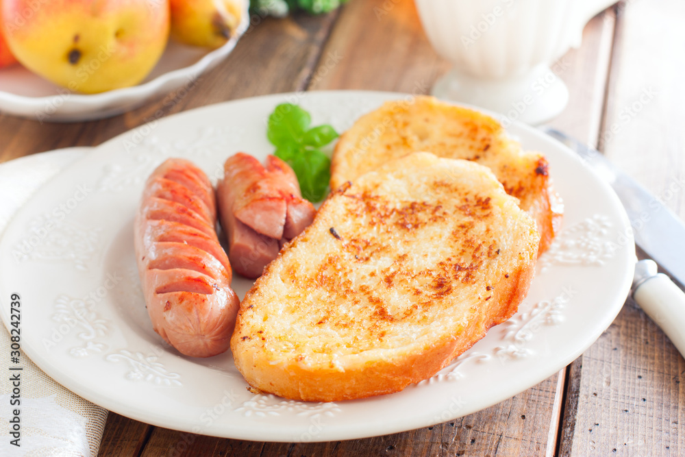 Toasted white bread on a plate on a wooden table, selective focus Toasted white bread on a plate on a wooden table, selective focus