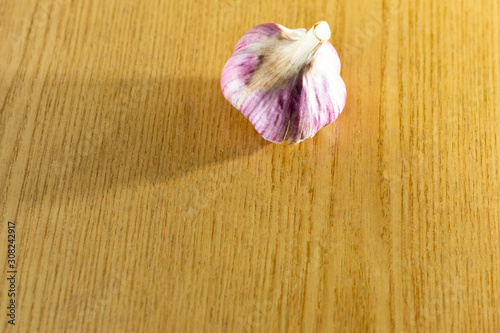 Head of dried blue garlic on a brown background.
