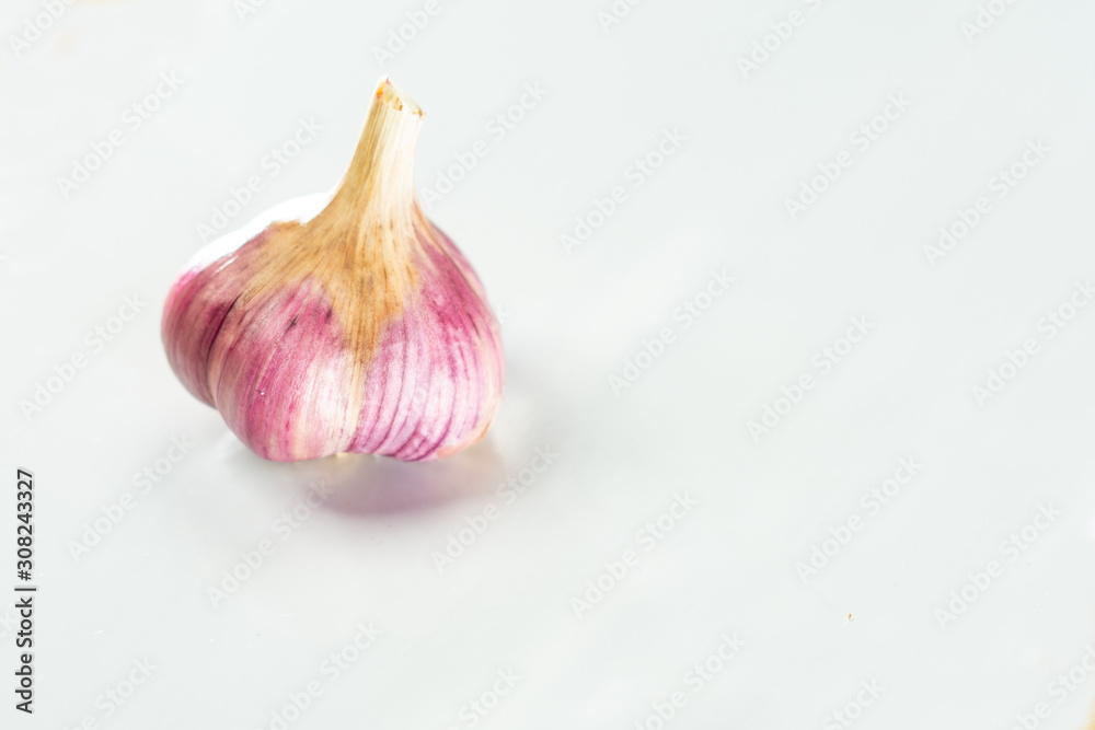 Fototapeta premium Head of dried blue garlic on a white background.