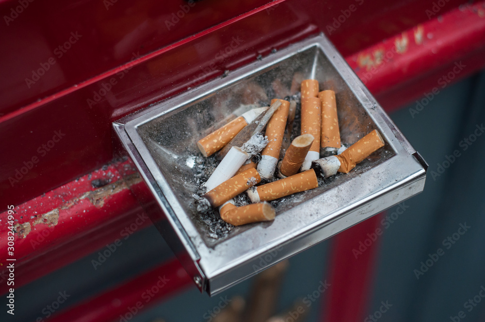 Closeup of pubic ashtray full of cigarettes in the street Closeup of pubic ashtray full of cigarettes in the street