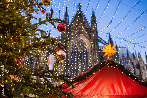 Traditional Christmas market in Europe, Cologne, Germany. Main town square with decorated tree and lights. Christmas fair concept