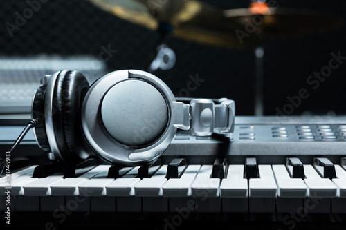 Wallpaper Mural Piano keyboard with headphones for music, Headphones on piano keyboard, close up,headphones on electric piano background by the music instruments background. Torontodigital.ca
