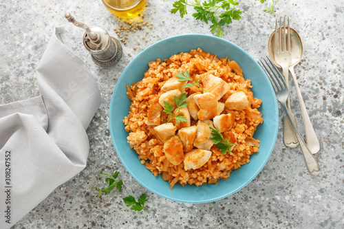 Fried cabbage, bulgur and chicken breast photo