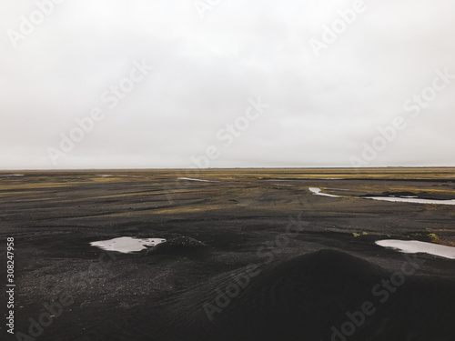 Black sand wasteland with water