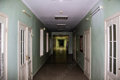 A Long corridor in the hospital. A corridor with doors and windows