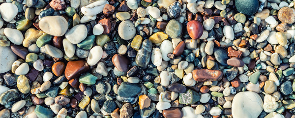Trendy colorful small sea stone pebble background. Multicolored abstract beach nature pattern