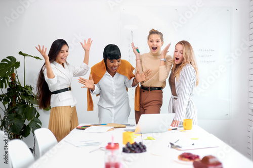 surprised excited coworking in office, happy diverse women together in shock, cheerful in office