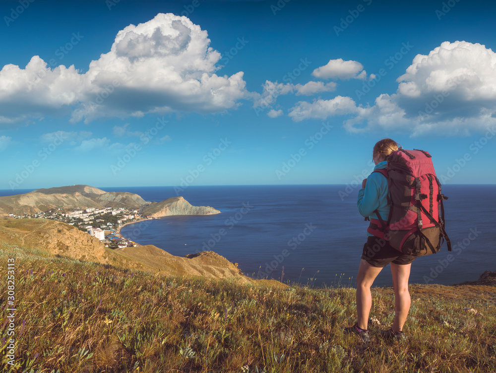Girl hiker above the sea