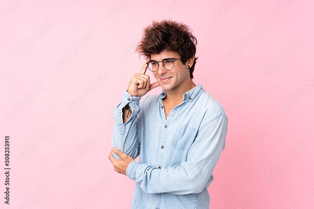 Young caucasian man over isolated pink background with glasses Young caucasian man over isolated pink background with glasses