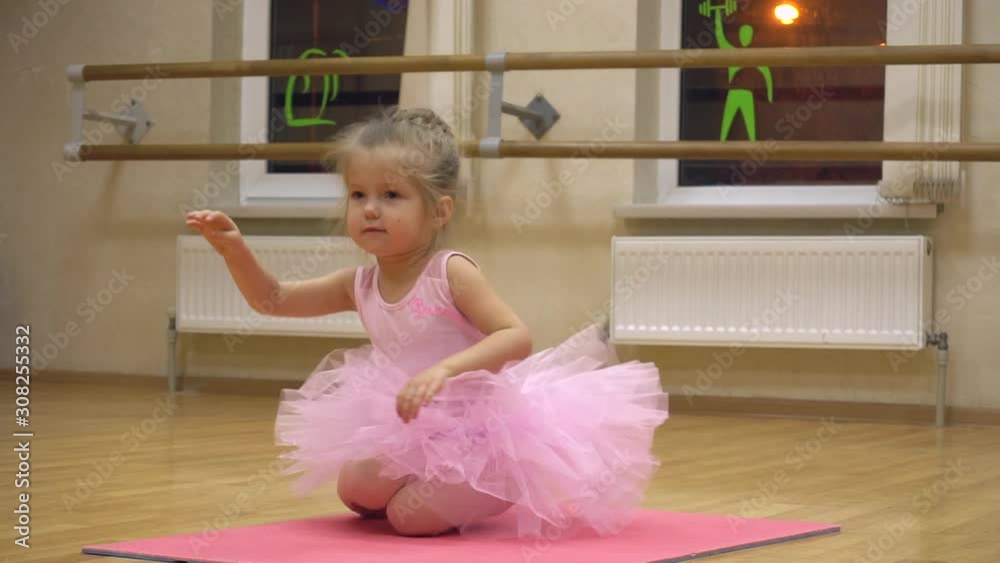 Little girl doing some ballet exercises in the choreography class Little girl doing some ballet exercises in the choreography class