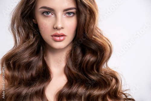 Portrait of a beautiful woman with a long brown hair.