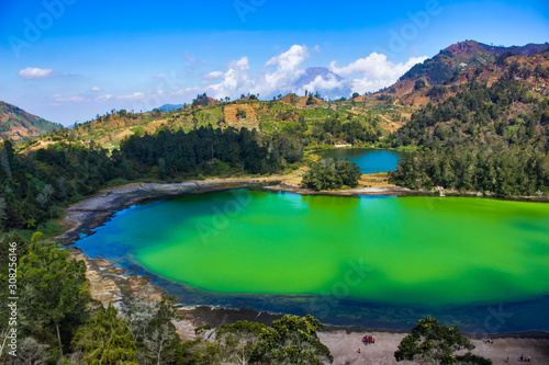 beautiful landscape view of the Telaga Warna lake surrounded by trees, taken from the height area/aerial view, selectively focused