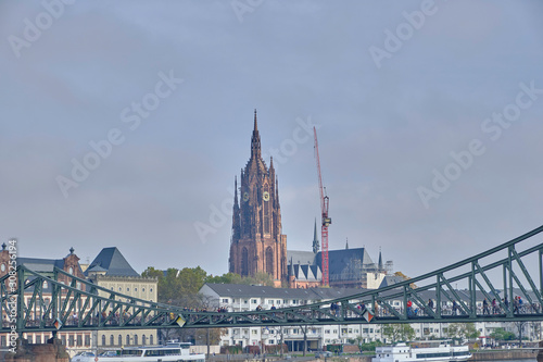 Scenic view of Frankfurt Cathedral (Frankfurter Dom) - Roman Catholic Gothic church located in centre of Frankfurt am Main in Germany. Beautiful cloudy summer look of christian temple in german city