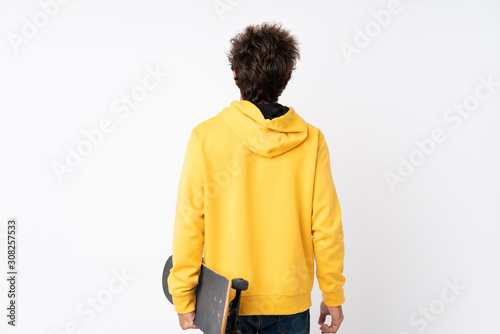 Handsome young skater man over isolated white wall