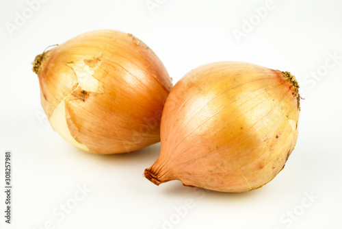 Fresh onion bulbs and onion slices isolated on white background