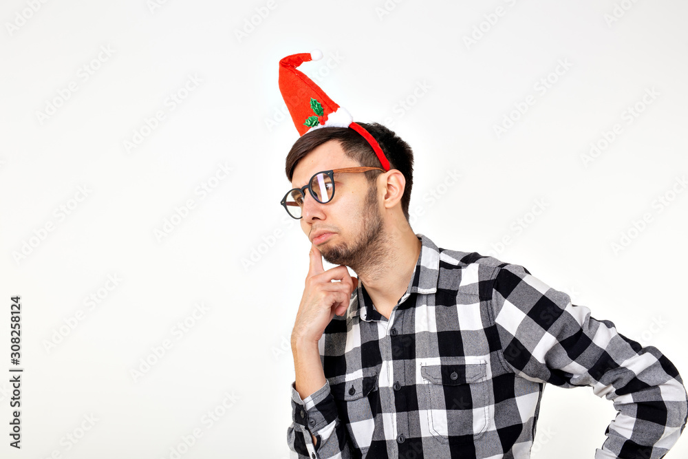 Holidays and presents concept - Funny emotional man in Christmas hat on white background with copyspace Holidays and presents concept - Funny emotional man in Christmas hat on white background with copyspace