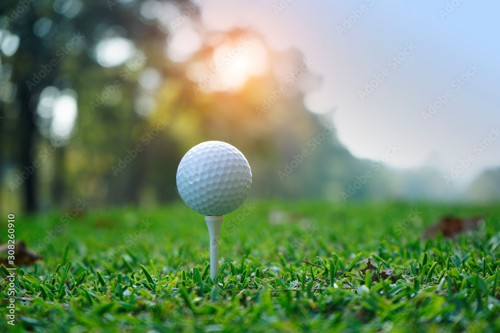 Golf ball on tee in beautiful golf course at sunset background. Golf ball on tee in beautiful golf course at sunset background.