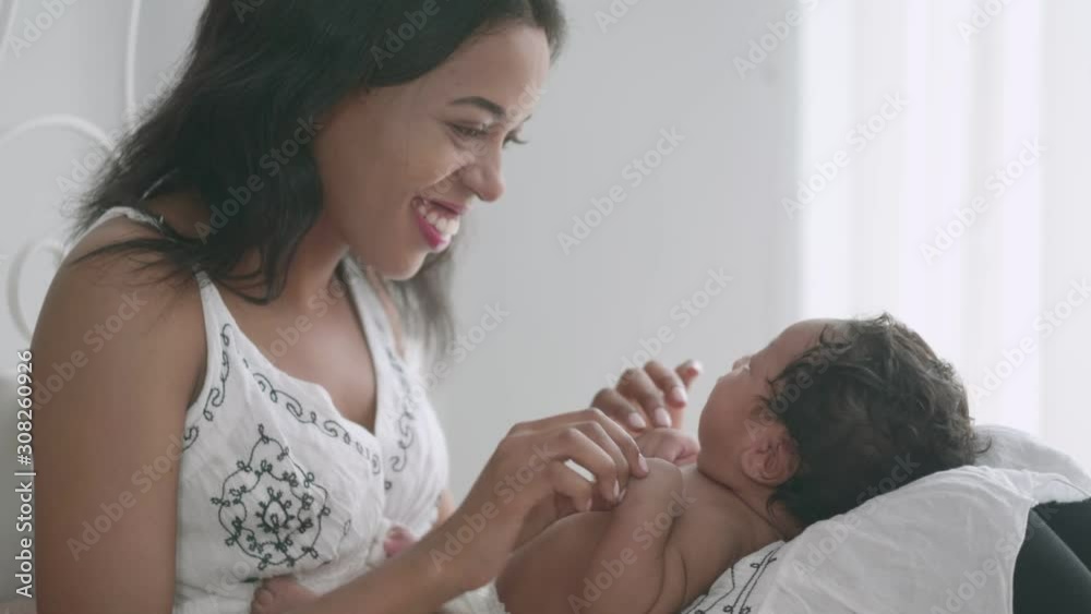 Mother is teasing with babies on her lap. Mother is teasing with babies on her lap.