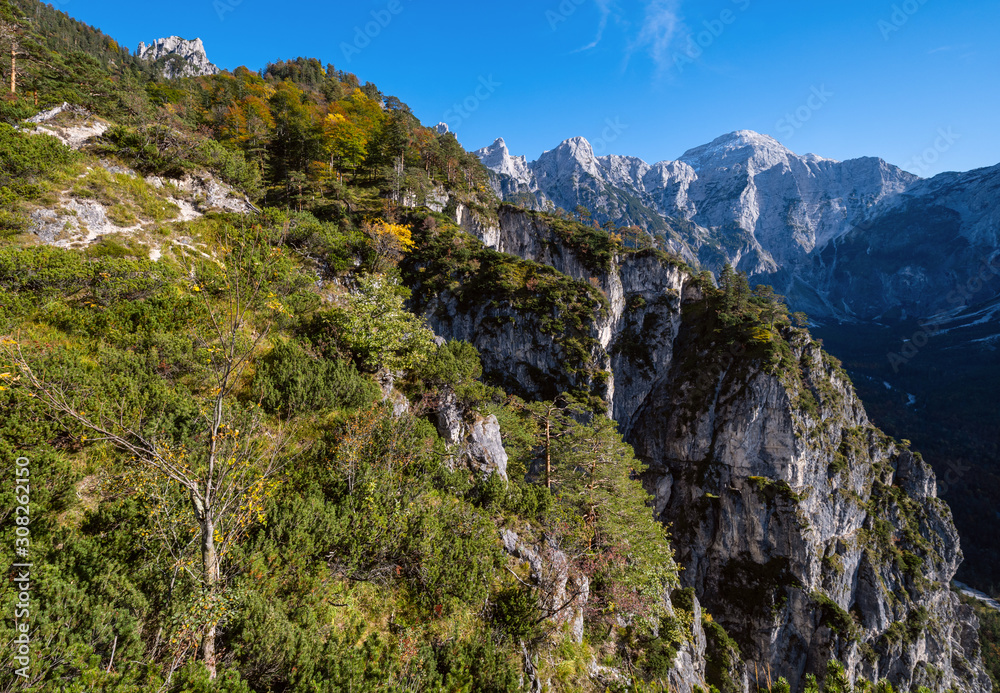 Sunny autumn alpine scene. Peaceful rocky mountain view from hiking path near Almsee lake, Upper Austria. Sunny autumn alpine scene. Peaceful rocky mountain view from hiking path near Almsee lake, Upper Austria.